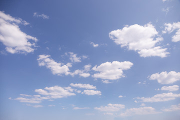 Clouds in a blue sky great for sky swaps and backgrounds - obrazy, fototapety, plakaty