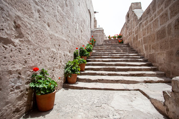Fototapeta na wymiar Stone stairs, along the stairs the monastery of Saint. Catalina, Arequipa, Peru