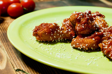 plate of chicken wings on wooden table