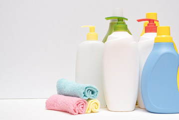 Detergent bottle and towels on white background.