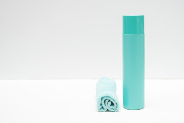 Detergent bottle and towels on white background.