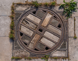Troyes, France - 09 08 2019: Wood and iron manhole cover