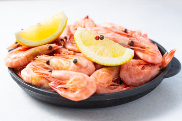Fresh organic shrimps with lemon juice and spices for healthy eating. Sea food concept.