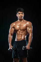 Fototapeta na wymiar Athlete bodybuilder. Strong and fit man. Sporty muscular guy with dumbbells. Sport and fitness motivation. Individual sports recreation.