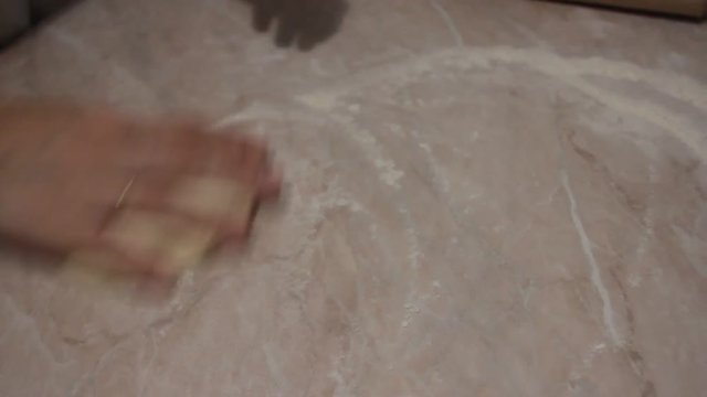 woman's hands knead the dough