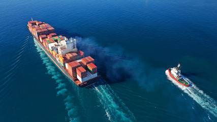 Aerial drone photo of industrial cargo container tanker ship carrier cruising the open ocean deep...