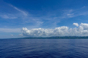 The hazy and mountainous coastline of the Caribbean Island of Haiti as a cruise ship sails by.
