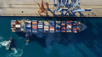Aerial drone top down photo of industrial cargo container tanker ship carrier docked in commercial...