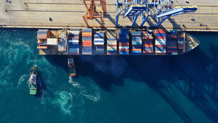 Aerial drone top down photo of industrial cargo container tanker ship carrier docked in commercial...