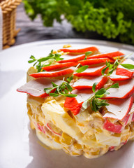 salad of fish sticks on dark wooden rustic background