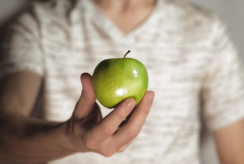Close up of man holding green apple. Concept of healthy food. Apple stock images