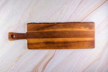 Wooden cutting board on a gray marble background