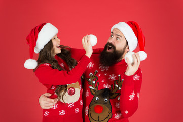 Having fun together. Greeting xmas tradition. happy family play snowball. father and daughter celebrate new year. family holiday fun. small girl and santa dad red background. merry christmas everyone
