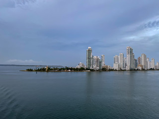 Fototapeta premium Cruising past the pennisula into the Cartagena, Columbia port early in a hazy morning.