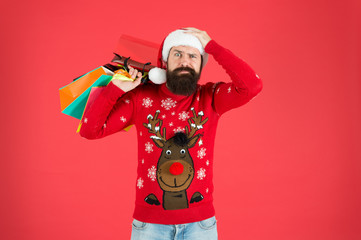 Seasonal sale. Shopping hobby. Take it all. Man on winter shopping. Guy wear knitted sweater and hat carry shopping bags. Bearded hipster customer. Consumerism concept. Wholesale and retail