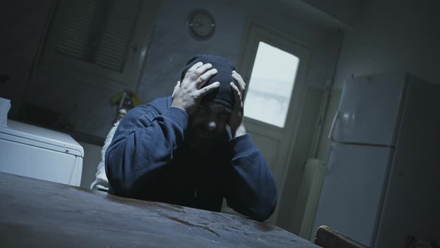 Depressed angry or paranoid man in despair alone at his old dirty house.