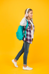 i am ready. hipster girl care backpack. schoolgirl casual style hold school bag. autumn kid fashion. child listen music headset. childhood education and development. happy childrens day. audio book