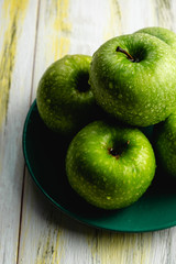 Fresh green apples on old wooden table. Healthy and ecological food. Color harmony