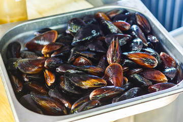 chef cooks mussels at the street food festival