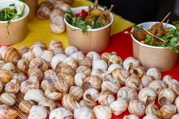 Fototapeta na wymiar snails at the counter of the street food festival