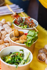 snails at the counter of the street food festival