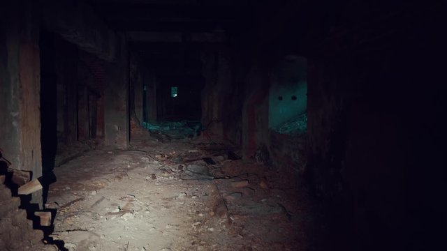 First-person view, walk with flashlight through dark creepy industrial tunnel or corridor with destruction and debris after crisis or disaster
