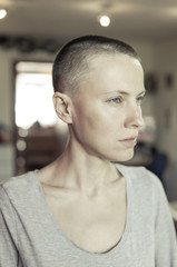 Portrait of a bald woman in a living room