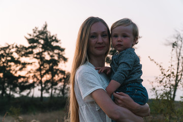 Family portrait of mother and her young son in the park. Family leisure outdoors in the natural landscape