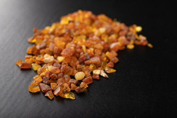 Small pieces of raw amber collected on a beach in Poland. Precious stones used for jewelry.