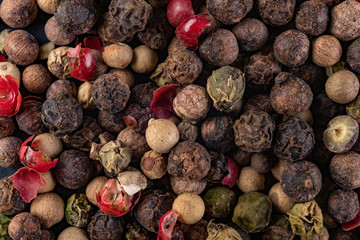 Colorful pepper on the kitchen table. Herbs for seasoning dishes in the home kitchen.