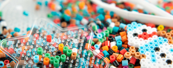 Set of perler beads. Perler pegboard, tweezers and many colorful fusible beads. Toy that develops...