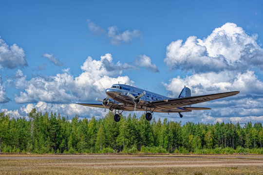 Short-haul transport aircraft with two piston engines Douglas DC-3A-447 OH-LCH Airveteran in Finnish Airlines livery take off from Karhula aviation museum airshow. Kotka, Finland.
