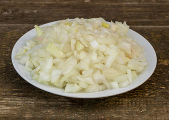 Sliced onion on wooden background, health benefits