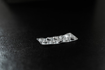 Empty blister from pills lies on the table