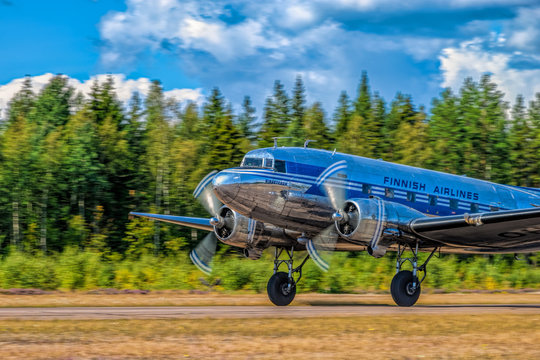 Short-haul transport aircraft with two piston engines Douglas DC-3A-447 OH-LCH Airveteran in Finnish Airlines livery take off from Kymi (EFKY) airfield. Kotka, Finland.