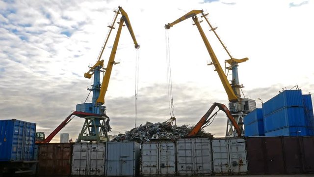 River port cranes load scrap metal into wagons