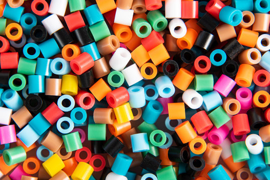 Set of multicolor fusible perler beads close up, top view. Kids toy that develops the imagination of child. Theme of leisure, hobby and development