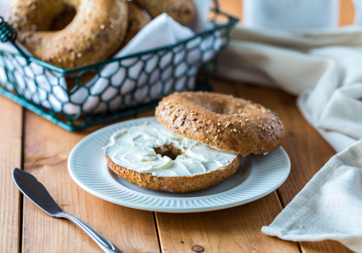 A multigrain bagel with cream cheese.