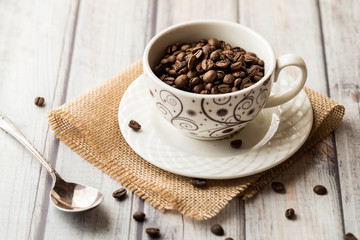 a cup full of coffee beans.