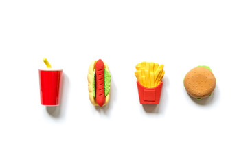 Varied miniature toy fast food in miniature with soft shadows isolated on a white background.