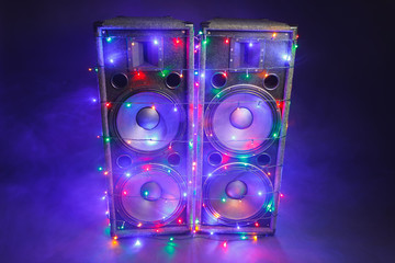 music speakers with festive Christmas lights and smoke