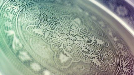 macro closeup on a handicraft classic metallic tray with Arabia or Islamic art pattern