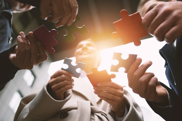 Teamwork of partners. Concept of integration and startup with puzzle pieces