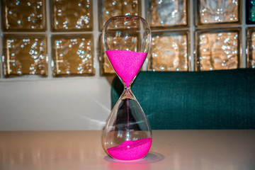 Hourglass on a white table in an office