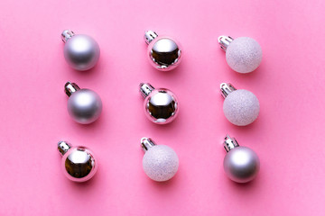 Christmas decoration balls isolated on pink background. Xmas pattern. Flat lay. Pattern winter bubble concept
