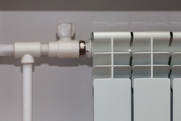 The white radiator and pipes of heating.