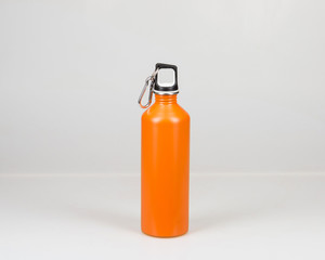 Aluminum water bottle, orange on white background. Camp water bottle.