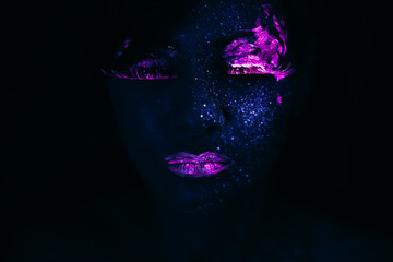 Portrait of Beautiful Fashion Woman in Neon UF Light. Model Girl with Fluorescent Creative Psychedelic MakeUp, Art Design of Female Model in UV