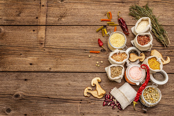 Zero waste food shopping concept. Cereals, pasta, legumes, dried mushrooms, spices. Sustainable lifestyle, old wooden boards background