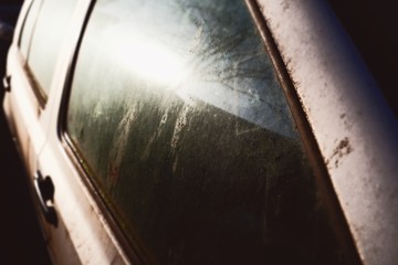 Old dirty car window close up 